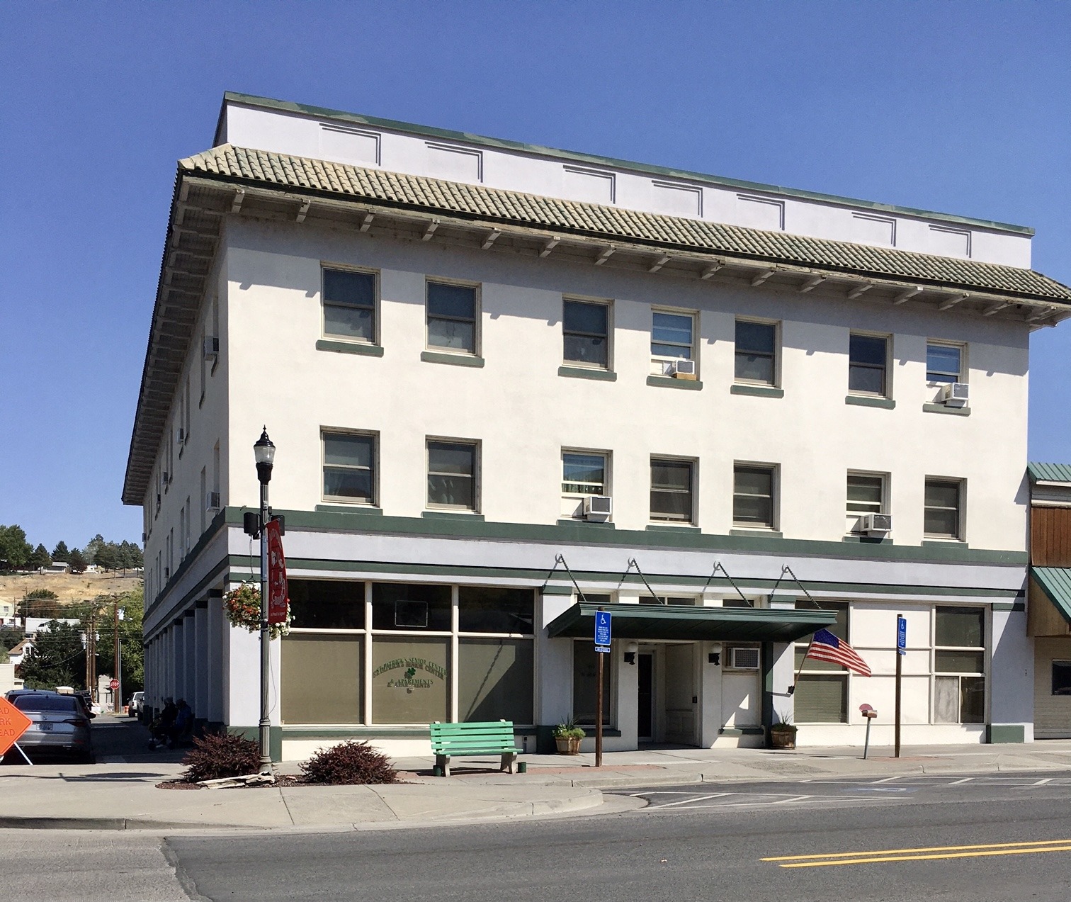 a large white building on the corner of a city street